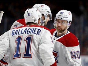 Canadiens linemates Brendan Gallagher, Tomas Tatar (90) and Phillip Danault talk strategy during break in action of NHL game against the Carolina Hurricanes at the Bell Centre in Montreal on Dec. 13, 2018.