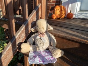 Neighbour Annie Lapierre left a note and stuffed bear on the porch of a home inMontreal where two children were killed in an apparent murder-suicide Oct. 22, 2019.