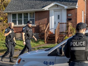 Police investigate the scene of a murder-suicide in Montreal Oct. 23, 2019. A 7- and 5-year-old were killed.