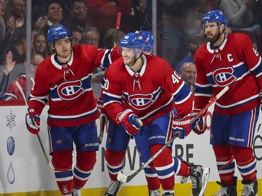 Montreal Canadiens Joel Armia, centre, skates to the bench with team-mates Max Domi, left, and Shea Weber after scoring goal against the San Jose Sharks during second period of National Hockey League game in Montreal Thursday October 24, 2019.