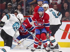 Montreal Canadiens winger Paul Byron tries to block shot by San Jose Sharks' Erik Karlsson during second period in Montreal on Oct. 24, 2019.  Canadiens' Jeff Petry and Sharks' Evander Kane watch at rear.