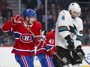 Montreal Canadiens Arturi Lehkonen and San Jose Sharks Brenden Dillon flinch as the puck hits Dillon during first period of National Hockey League game in Montreal Thursday October 24, 2019.