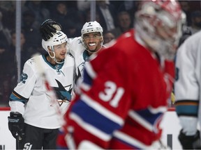 Canadiens goalie Carey Price skates away as Sharks' Kevin Labanc, left, is congratulated by team-mate Evander Kane after scoring goal during second period Thursday night at the Bell Centre.