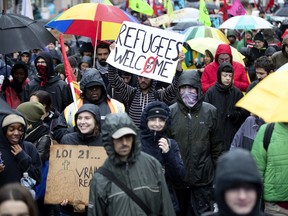 A small crowd braves the rain in Montreal to take part in a march to denounce racism and Quebec's Bill 21 on Sunday, Oct. 27, 2019.