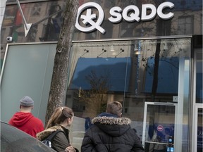 People wait outside the SQDC store on Ste-Catherine St. on Wednesday October 30, 2019.
