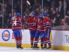 Canadiens defenceman Victor Mete (middle) is congratulated by captain Shea Weber and teammates after scoring his first NHL goal in first period of game against the Minnesota Wild at the Bell Centre in Montreal on Oct. 17, 2019.