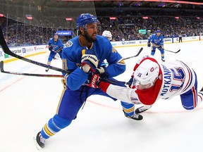 ST LOUIS, MO - OCTOBER 19: Robert Bortuzzo #41 of the St. Louis Blues defends against Jesperi Kotkaniemi #15 of the Montreal Canadiens at Enterprise Center on October 19, 2019 in St Louis, Missouri.