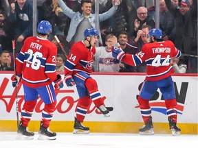 Canadiens' Nick Suzuki (14) celebrates his goal with  teammates Jeff Petry (right) and Nate Thompson versus the Maple Leafs on Saturday, Oct. 26, 2019.