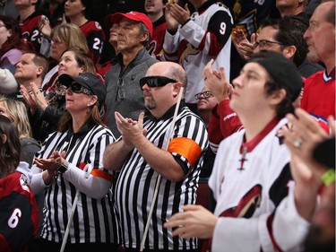Fans at the Coyotes-Habs game in Arizona Oct. 30 dressed as blind referees.