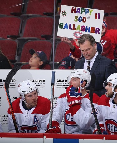Habs' Brendan Gallagher sits on the bench as a fan holds a sign congratulating him for playing in his 500th career game Oct. 30, 2019 in Glendale, Arizona.