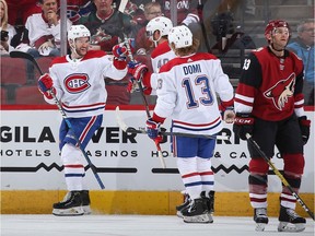 Jonathan Drouin of the Montreal Canadiens celebrates with Joel Armia #40 and Max Domi #13 after scoring a goal against the Arizona Coyotes during the third period at Gila River Arena on Oct. 30, 2019 in Glendale, Ariz. The Canadiens defeated the Coyotes 4-1.