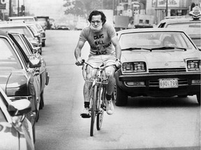 "Bicycle Bob" Silverman wears a mask while cycling in traffic in Montreal in 1976.