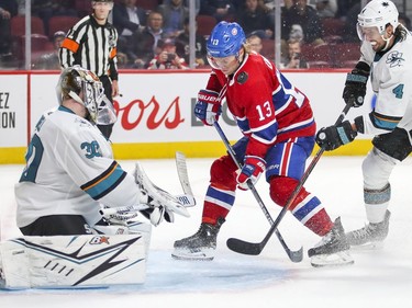 Montreal Canadiens Max Domi gets hit in the face by the puck between by San Jose Sharks goalie Aaron Dell and defenceman Brenden Dillon during third period of National Hockey League game in Montreal Thursday October 24, 2019.