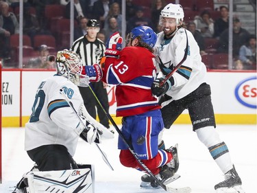 Montreal Canadiens Max Domi is cross checkey by San Jose Sharks defenceman Brenden Dillon in front of  goalie Aaron Dell during third period of National Hockey League game in Montreal Thursday October 24, 2019.