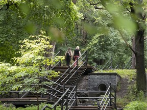 Two women begin the long steep climb up the stairs towards Mount Royal in Montreal