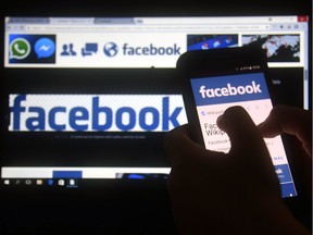 A cellphone and a computer screen display the logo of the social networking site Facebook on March 22, 2018, in Asuncion. Zuckerberg on March 22 failed to quell outrage over the hijacking of personal data from millions of people, as critics demanded the social media giant go much further to protect privacy.
