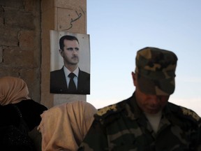 A portrait of Syrian President Bashar Assad is seen outside the Suran crossing point, close to the Syrian-Turkish border on September 25, 2019.