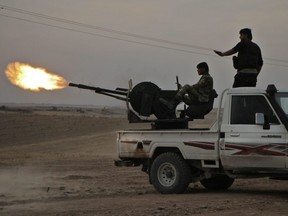 Turkish-backed Syrian fighters fire a truck mounted heavy gun near the town of Tukhar, north of Syria's northern city of Manbij, on October 14, 2019, as Turkey and it's allies continues their assault on Kurdish-held border towns in northeastern Syria.