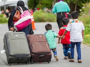 Asylum seekers walk along Roxham Rd. near Champlain, N.Y. en route to the Canada/U.S. border.