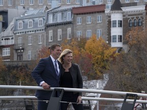 Conservative Leader Andrew Scheer and his wife Jill Scheer walk across a bridge following a campaign stop in Quebec City, Tuesday October 15, 2019.
