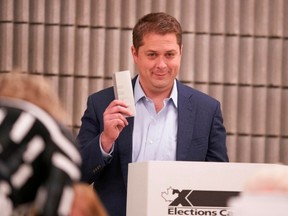 Conservative leader Andrew Scheer looks on next to a voting booth in Regina, Saskatchewan on October 21, 2019.