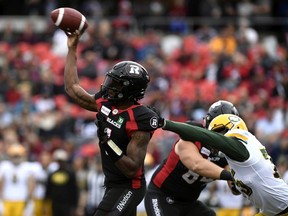 Eskimos defensive lineman Nick Usher  tries to hold back Redblacks quarterback Dominique Davis during CFL action in September. Davis will get the starting nod at QB in Ottawa's season finale vs. the Alouettes.