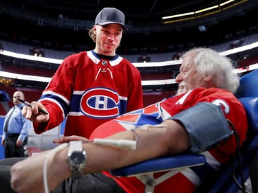 Max Domi chats with Fernand Suprenant during the annual Montreal Canadiens' blood drive at the Bell Centre on Wednesday, Oct. 23, 2019.