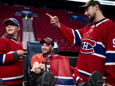 Tomas Tatar jokes with Brandon Taillefer, left, and his father, Justin Alrie, during the annual Montreal Canadiens' blood drive at the Bell Centre on Wednesday, Oct. 23, 2019.