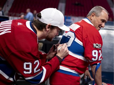 Jonathan Drouin signs a jersey for Alain Flibotte during the annual Montreal Canadiens' blood drive at the Bell Centre on Wednesday, Oct. 23, 2019.