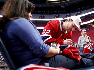 Jonathan Drouin signs a jersey for Mona Anand during the annual Montreal Canadiens' blood drive at the Bell Centre on Wednesday, Oct. 23, 2019.