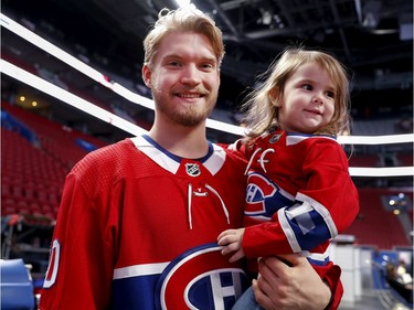 Three-year-old Zoe Garcaeu gets a boost from Joel Armia during the annual Montreal Canadiens' blood drive at the Bell Centre on Wednesday, Oct. 23, 2019.