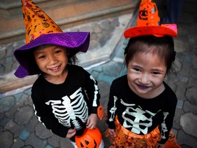 While many children in Montreal and other Quebec municipalities were forced to sit out Halloween on Thursday evening, trick-or-treaters were out in force around the world, including these two in a village in Bangkok, Thailand.