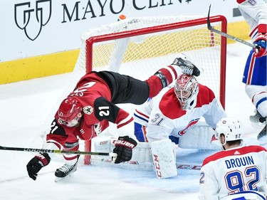 Arizona Coyotes centre Derek Stepan (21) trips over Montreal Canadiens goaltender Carey Price (31) during the second period at Gila River Arena.