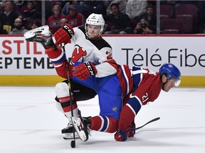 Devils defenseman Colton White (2) and Montreal Canadiens forward Nick Cousins (21) collide during the first period of a preseason game at the Bell Centre on Sept. 16, 2019.