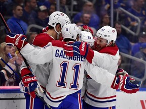 Montreal Canadiens left wing Jonathan Drouin (92) is congratulated by centre Nick Cousins (21) and right wing Brendan Gallagher (11) after scoring during the second period at Enterprise Center.