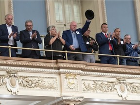 Huron Wendat grand chief Konrad Sioui raises his hat while members of the National Assembly applaud after Premier François Legault apologized to First Nations and Inuit leaders on Wednesday.