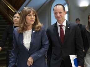 Quebec Finance Minister Eric Girard, right and Quebec Culture and Communications Minister Nathalie Roy walk to a news conference to announce measures to help media, Wednesday, October 2, 2019 at the legislature in Quebec City.