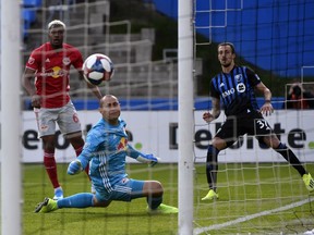 Montreal Impact Impact forward Maximiliano Urruti scores on New York Red Bulls goalkeeper Luis Robles during the first half in Montreal on Sunday, Oct. 6, 2019.