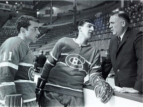 Danny Grant (No. 11) and Serge Savard chat with Canadiens GM Sam Pollock during NHL training camp in 1967.