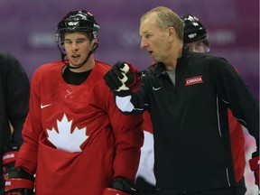 Team Canada coaching consultant Ralph Krueger, speaks with Sidney Crosby during a practice at the 2014 Olympic Winter Games in Sochi, Russia, on Feb. 11, 2014.