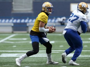 Quarterback Chris Streveler (left) looks for a running lane after faking a handoff to Johnny Augustine during Winnipeg Blue Bombers practice on Wednesday, Oct. 9, 2019.