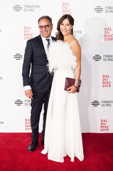 1019_social_0445: FEATHER ME HAPPY: Power pair and great ball supporters, SID LEE CEO Bertrand Cesvet and wife, lawyer/best-selling author Josée Noiseux, in Xavier Laruelle, at the 2019 MAC BALL. ALBERT ZABLIT