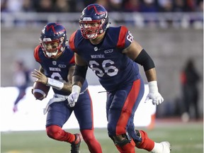 Montreal Alouettes offensive-lineman Trey Rutherford leads the blocking for quarterback Vernon Adams Jr. against the Calgary Stampeders in Montreal on Oct. 5, 2019.