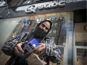 Tchad Fakhoury holds up his latest purchase of cannabis from the Ste Catherine street SQDC store. The first SQDC location on the West Island will be open by March, 2020.