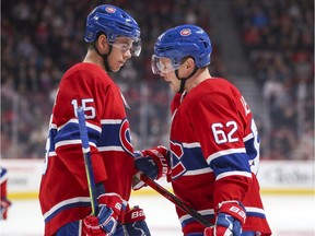 Montreal Canadiens' Jesperi Kotkaniemi, left, and Artturi Lehkonen talk during a break in play against the San Jose Sharks in Montreal on Oct. 24, 2019.