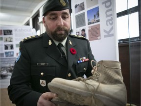Royal Montreal Regiment Captain Alan Vincent, holds boots from Canadians soldiers that where deployed in Afganistan, during the Remembering Afghanistan: Reflections of Canadian Soldiers held at the Royal Montreal Regiment, starting on Thursday October 31, 2019.