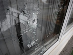 A window is shattered by bullet fire after a shooting on 26th Ave in the RDP district of Montreal, on Thursday, October 31, 2019.