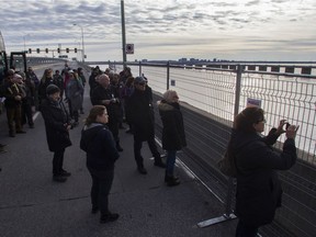 People look over toward the ice bridge and Nun's Island during a tour of the old Champlain Bridge on Saturday, Nov. 2, 2019.