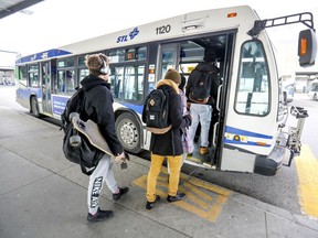 Passengers get on Laval Transit buses at the Montmorency métro station in Laval on Saturday, Nov. 2, 2019. The STL guarantees its buses will run on time. Customers who are not satisfied with any number of performance benchmarks set by the agency can get their money back.