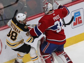 Canadiens goaltender Carey Price and Bruins' David Pastrnak mix it up behind Montreal's goal Tuesday night at the Bell Centre.